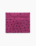 Pink cardholder with black polka dots on a white background